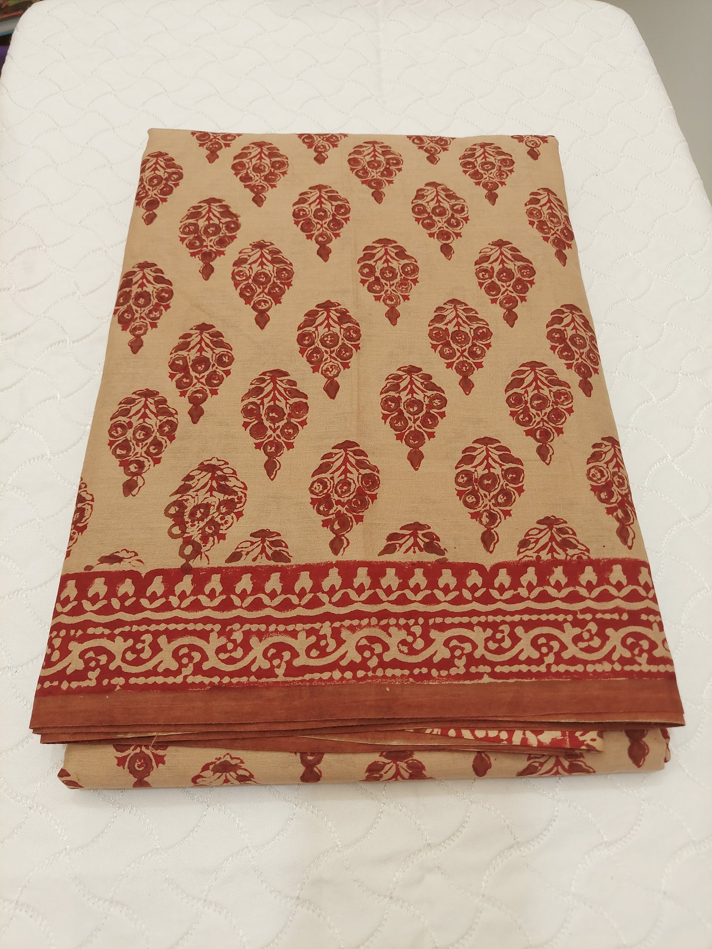 Rich maroon hand block prints on a warm earthy base