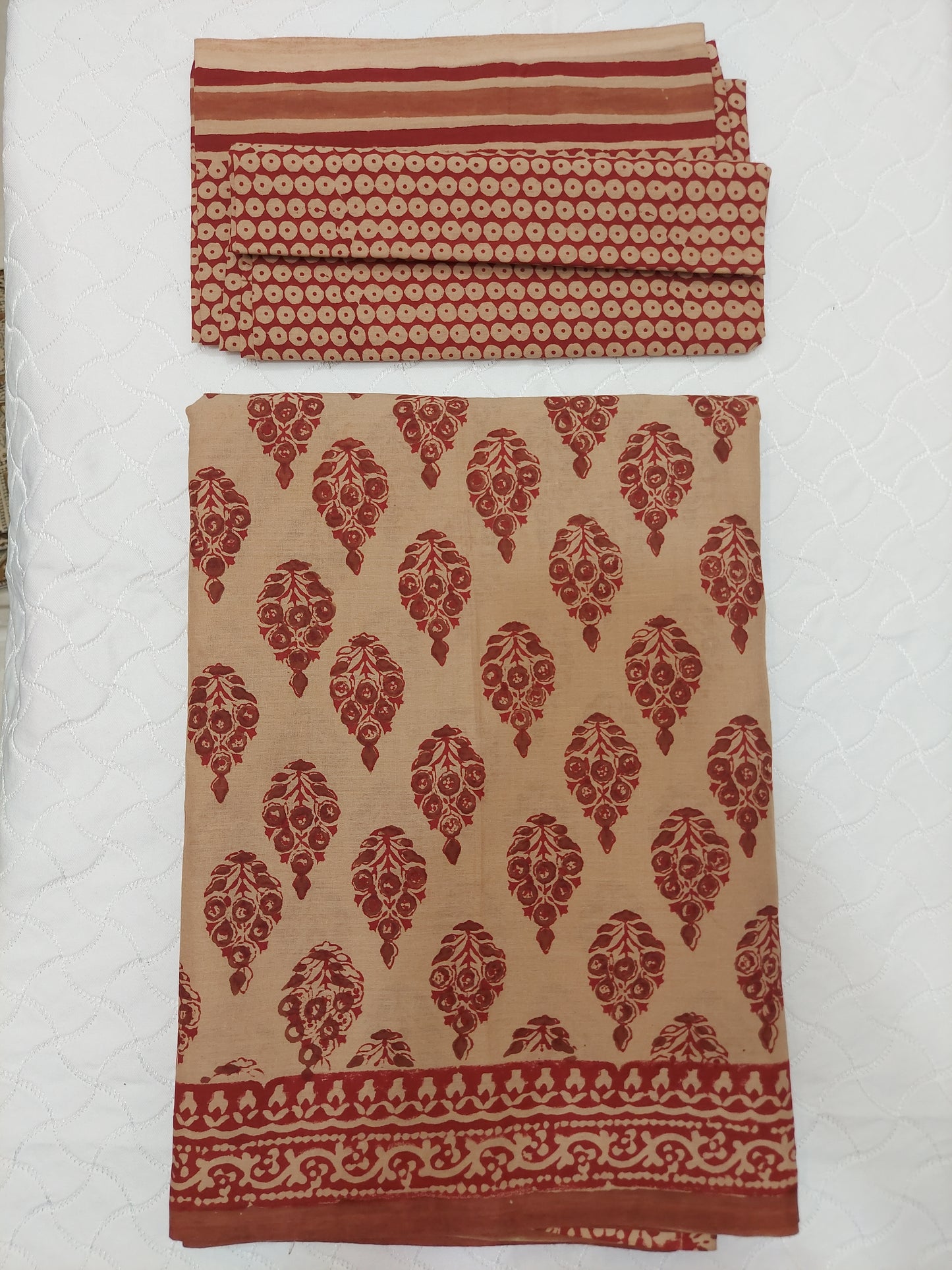 Rich maroon hand block prints on a warm earthy base