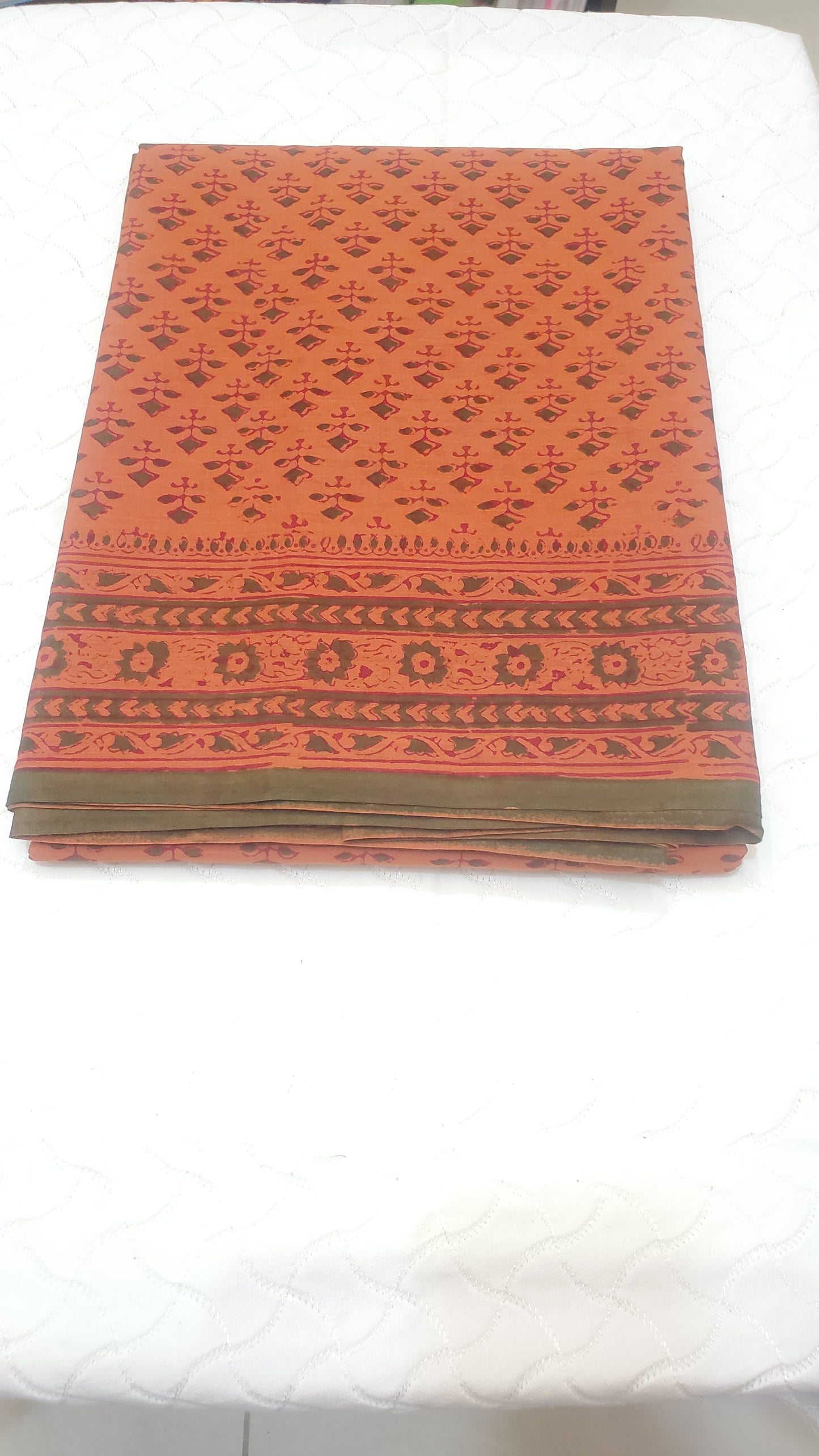 Rust orange beauty features classic hand block floral motifs and intricate borders