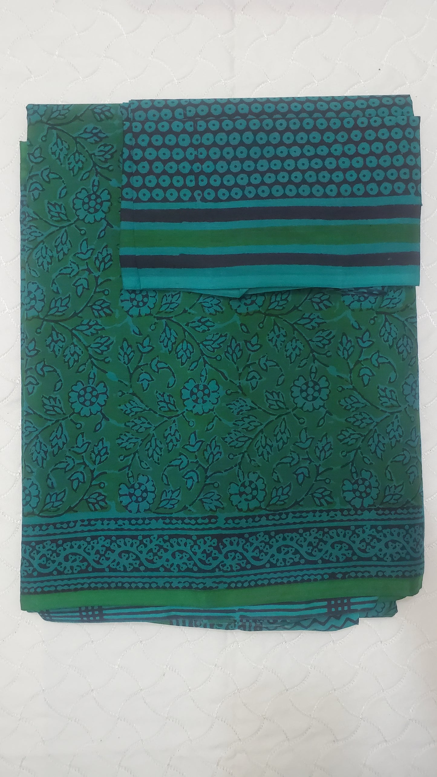 Vibrant green saree with intricate floral block prints in deep indigo tones