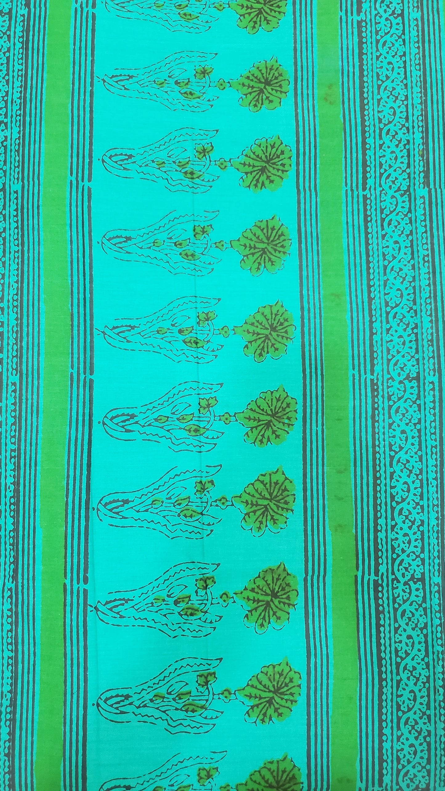 Vibrant green saree with intricate floral block prints in deep indigo tones