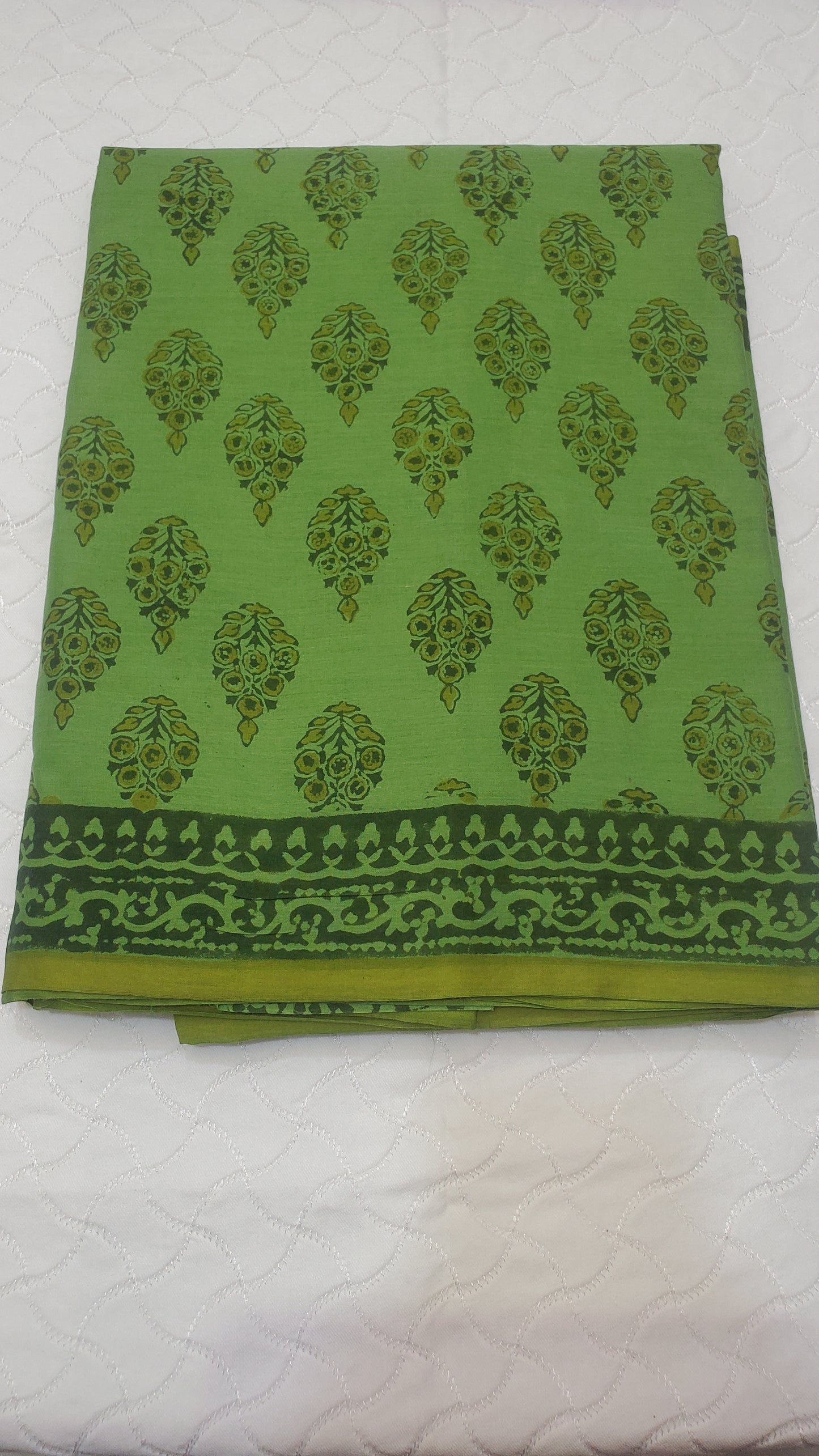 Lush green saree with intricate floral motifs
