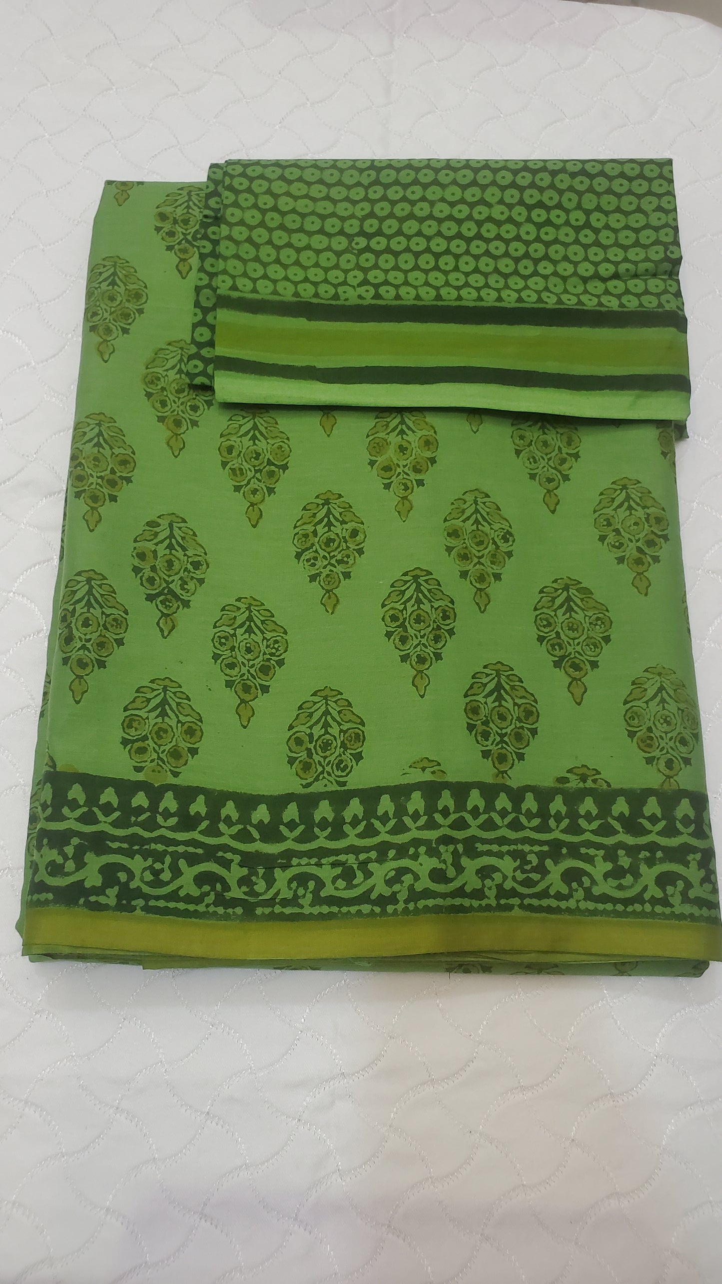Lush green saree with intricate floral motifs