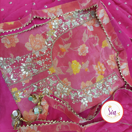 Premium Pure Organza with Handwork in a vibrant Fuchsia Pink, enhanced with delicate floral prints.