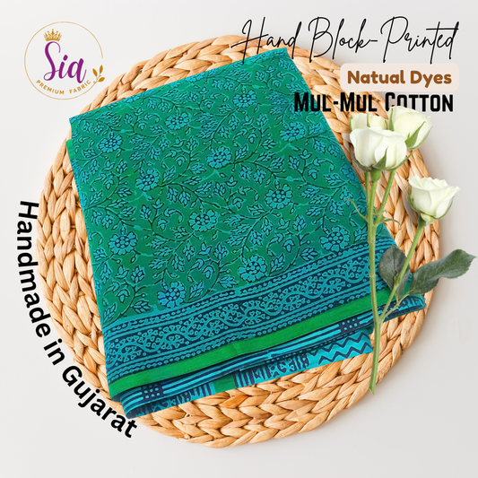 Vibrant green saree with intricate floral block prints in deep indigo tones